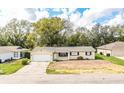 Charming single-story home with a well-manicured lawn and attached two-car garage at 1548 Churchill Ct, Lakeland, FL 33801