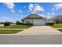 Well-maintained house with a manicured lawn, a spacious driveway and a two car garage at 1706 Tressel Ct, Winter Haven, FL 33881