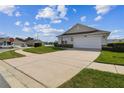 Attractive home exterior with lush green lawn, and a spacious two car garage at 1706 Tressel Ct, Winter Haven, FL 33881