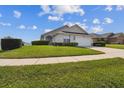 Charming single-story home with a well-maintained lawn and a spacious driveway at 1706 Tressel Ct, Winter Haven, FL 33881