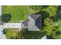 Birds-eye view of a grey roofed home featuring a long driveway and surrounding greenery at 186 Rosedale Dr, Deltona, FL 32738