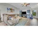 Cozy living room featuring a comfortable sectional sofa, wood-look flooring, and a ceiling fan at 2173 Mission Hills Dr, Lakeland, FL 33810