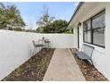 Charming courtyard with a table, chairs, bench, and well-maintained landscaping near the entrance at 2326 Eastmeadows Rd, Lakeland, FL 33812