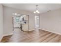 Open-concept dining area with wood floors and easy access to kitchen and other rooms at 2638 Ralph Rd, Lakeland, FL 33801