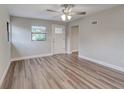 Bright living room featuring wood flooring, a ceiling fan, and a freshly painted interior at 2638 Ralph Rd, Lakeland, FL 33801