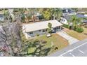 An elevated angle displaying the home's tidy front lawn, fresh paint, and metal roof at 3207 S Polk Ave, Lakeland, FL 33803