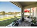 View of a beautiful screened porch with multiple plants overlooking the lake and landscaped backyard at 3882 Rollingsford Cir, Lakeland, FL 33810