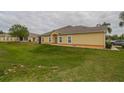 Well-maintained yellow home featuring a tidy lawn and classic architecture at 4010 Winding Vine Dr # 4010, Lakeland, FL 33812