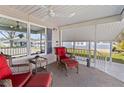 Inviting front porch with wicker furniture, ceiling fan, and views of the neighborhood at 4911 Colonnades Club Blvd, Lakeland, FL 33811