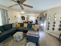 Comfortable living room featuring a large blue sectional sofa with yellow accent pillows at 5377 Quarry Rock Rd, Lakeland, FL 33809