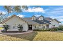 Charming single-Gathering home featuring meticulous landscaping, brick pathway and double-door entryway at 5435 Myrtle Hill W Dr, Lakeland, FL 33811