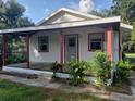 View of the side exterior showcasing the covered porch with red supports at 5515 3Rd Se St, Lakeland, FL 33812