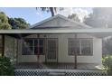 Inviting front exterior of home featuring covered porch with lattice and ample natural light at 5515 3Rd Se St, Lakeland, FL 33812