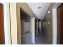 Hallway features in-unit laundry with stacked washer and dryer units at 6043 Topher Trl # 6043, Mulberry, FL 33860