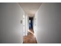 Long hallway featuring tile flooring and white walls throughout the home at 6055 Topher Trl # 6055, Mulberry, FL 33860