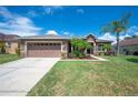 Charming single-story home with a well-manicured lawn and a two-car garage at 6339 Alamanda Hills Dr, Lakeland, FL 33813