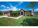 Charming single-story home with a well-manicured lawn and a two-car garage at 6339 Alamanda Hills Dr, Lakeland, FL 33813