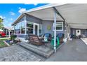 Inviting covered porch featuring cozy wicker furniture, offering a relaxing outdoor living space at 6792 Brentwood Ne Dr, Winter Haven, FL 33881