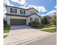 Two-story home with a two-car garage, dark shutters, and a manicured lawn at 685 Meadow Pointe Dr, Haines City, FL 33844