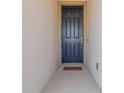 Contemporary blue front door with welcome mat at 685 Meadow Pointe Dr, Haines City, FL 33844