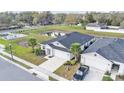 Aerial view of home with pond, and palm tree landscaping at 7187 Cruz Ct, Lakeland, FL 33813