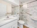 Bright bathroom featuring a marble-look shower with glass doors and a well-lit vanity at 8350 Split Creek Cir, Lakeland, FL 33809