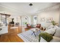 Open living room with hardwood floors, spiral staircase, and ample natural light at 949 Success Ave, Lakeland, FL 33801