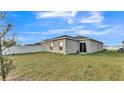 A home with a spacious, fenced backyard perfect for outdoor entertaining and a sliding glass door at 965 Eagle Rock Ter, Winter Haven, FL 33880