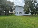 A well-kept two-story home with neat lawn, complemented by mature trees offering shade and natural beauty at 117 Tremont Dr, Winter Haven, FL 33884