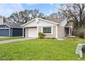 Single Gathering home featuring a well-maintained front lawn and attached single car garage at 1317 Bramblewood Dr, Lakeland, FL 33811