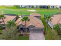 Beautiful home with tile roof, lush landscaping and a golf course view at 1420 Mickelson Ct, Davenport, FL 33896