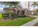 Charming single-story home with a manicured lawn, a tile roof and a three-car garage at 1420 Mickelson Ct, Davenport, FL 33896