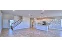 Open-concept living area with bright tile floors at 1501 Leamington Ln, Winter Haven, FL 33884