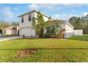 Two-story home with a two-car garage and verdant landscaping at 1526 Country Chase St, Lakeland, FL 33810