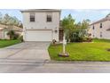 Inviting two-story home showcasing a well-maintained lawn and charming front yard landscaping at 1526 Country Chase St, Lakeland, FL 33810