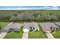 An aerial view of a single-Gathering home nestled among trees, featuring a well-kept lawn at 153 Heritage Park Ln, Mulberry, FL 33860