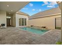 Serene outdoor pool area with waterfall feature, perfect for relaxation and entertainment at 168 Hampton Loop, Davenport, FL 33837