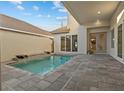 Private backyard pool featuring a small waterfall, ample patio space, and outdoor living at 168 Hampton Loop, Davenport, FL 33837