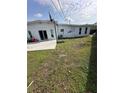 Spacious backyard with a large concrete patio and lawn at 1771 Bayview Dr, Lakeland, FL 33805