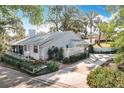 A single-story home featuring a well-kept lawn, driveway, and white fence, offering a welcoming ambiance at 21 Townhill Dr, Eustis, FL 32726