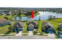 Aerial view of the property, showcasing its location and surrounding neighborhood near a lake at 2443 Torrens Dr, Lakeland, FL 33805