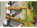 An aerial view of a property with a well-maintained lawn, privacy fence, and proximity to a tranquil lake at 2443 Torrens Dr, Lakeland, FL 33805