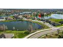 Scenic aerial view of the home nestled by a serene lake in a residential neighborhood at 2443 Torrens Dr, Lakeland, FL 33805
