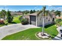 Well-maintained home exterior with mature landscaping, paver driveway and attached two car garage at 246 Laynewade Rd, Polk City, FL 33868