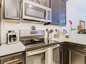 Close-up of kitchen featuring stainless steel appliances, white tile backsplash, and quartz countertops at 2820 Attwater Loop, Winter Haven, FL 33884