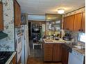 Functional kitchen featuring warm wood cabinetry and modern appliances at 3030 Sun Way, Lakeland, FL 33801