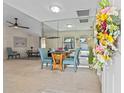 Bright dining area featuring mirrored wall, round table with blue chairs and a flower arrangement at 3158 Pebble Bend Dr, Lakeland, FL 33810