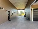 Spacious carport area with access to the garage and back entrance offering convenient covered parking at 394 Nolane Ln, Polk City, FL 33868