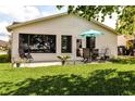 Relaxing backyard patio with outdoor seating, perfect for entertaining and enjoying peaceful moments at 3976 Cypress W Lndg, Winter Haven, FL 33884