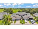 An inviting two-story townhome with a two-car garage and lush green surroundings at 42 Enclave Dr, Winter Haven, FL 33884